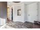 Bright entryway with wood-look floors, a white front door, and a decorative recessed ceiling at 2785 S Lisbon Way, Aurora, CO 80013