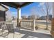 Inviting covered front porch with chairs and a view of the peaceful neighborhood street at 2785 S Lisbon Way, Aurora, CO 80013