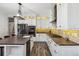 Modern kitchen featuring stainless steel appliances, a large island, and bright white cabinetry at 2785 S Lisbon Way, Aurora, CO 80013