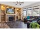 Bright living room features a fireplace, custom built-ins, and a comfortable leather sofa at 2785 S Lisbon Way, Aurora, CO 80013