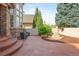 Backyard patio featuring stone steps, a rock garden, lush landscaping, and outdoor seating at 155 S Poplar St, Denver, CO 80230