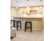 A finished basement bar area features modern lighting, bar seating, and a wood countertop at 155 S Poplar St, Denver, CO 80230