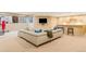 A finished basement with a large sectional couch, bar area and mounted television at 155 S Poplar St, Denver, CO 80230