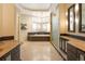 Bright bathroom with double sinks, soaking tub, and spa like feel at 155 S Poplar St, Denver, CO 80230