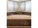 Spa-like bathroom featuring a large tub surrounded by natural light at 155 S Poplar St, Denver, CO 80230