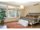 Serene bedroom featuring custom bed frame, large windows, and lots of light at 155 S Poplar St, Denver, CO 80230