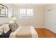 A cozy bedroom with hardwood floors, a plush bed, and bright natural light at 155 S Poplar St, Denver, CO 80230