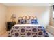 A tranquil bedroom features a stylish bed, elegant lamp, and ample natural light at 155 S Poplar St, Denver, CO 80230