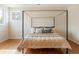 A bright bedroom features hardwood floors, a four-poster bed and a side window at 155 S Poplar St, Denver, CO 80230