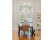 Dining area features a long wooden table with seating for eight, with plenty of natural light at 155 S Poplar St, Denver, CO 80230