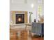 Living area featuring a stone fireplace with glass doors and hardwood floors, creating a cozy ambiance at 155 S Poplar St, Denver, CO 80230