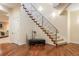 An elegant foyer features hardwood floors, a staircase with iron railings, and ample lighting at 155 S Poplar St, Denver, CO 80230