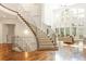 Elegant foyer showcasing a sweeping staircase with decorative metal railings, hardwood floors, and open layout at 155 S Poplar St, Denver, CO 80230