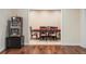 A finished game room features a vintage slot machine, game table and hardwood floors at 155 S Poplar St, Denver, CO 80230