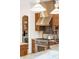 Gourmet kitchen featuring stainless steel appliances, custom range hood, and granite countertops at 155 S Poplar St, Denver, CO 80230