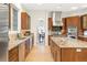 Kitchen with custom wood cabinets, granite countertops, and stainless steel appliances at 155 S Poplar St, Denver, CO 80230