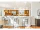 Bright kitchen featuring white countertops, wood cabinets, stainless steel appliances, and bar seating at 155 S Poplar St, Denver, CO 80230