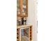 Kitchenette featuring dark wood cabinets, granite countertop, and a wine fridge at 155 S Poplar St, Denver, CO 80230
