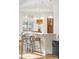 Kitchen area featuring white marble countertops, pendant lighting, and light wood cabinets at 155 S Poplar St, Denver, CO 80230