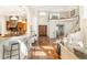 Open concept home showcasing a curved staircase, bar seating, and views of the kitchen and entryway at 155 S Poplar St, Denver, CO 80230