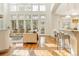 Bright and airy living room with many windows, a modern sofa set, and access to the backyard at 155 S Poplar St, Denver, CO 80230