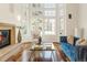Cozy living room with a fireplace, large windows, comfortable seating, and hardwood floors, perfect for relaxing at 155 S Poplar St, Denver, CO 80230