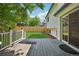 Back deck leading to a grassy, fenced yard at 5612 S Jebel Way, Centennial, CO 80015