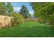 Large backyard with healthy green grass and wooden fence at 5612 S Jebel Way, Centennial, CO 80015