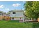 The back of the house with a backyard, patio, and wooden fence at 5612 S Jebel Way, Centennial, CO 80015