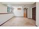 Unfinished basement with neutral carpet, closet, and bright window at 5612 S Jebel Way, Centennial, CO 80015