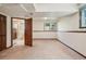 Open basement area with plush carpet, a window, and access to an updated bathroom, perfect for a den at 5612 S Jebel Way, Centennial, CO 80015
