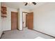 Bedroom featuring plush carpet, a ceiling fan, shelving, and two doors offering multiple access points at 5612 S Jebel Way, Centennial, CO 80015