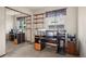 Bright room with a large mirrored closet, shelving, and a desk area perfect for an office or workspace at 5612 S Jebel Way, Centennial, CO 80015