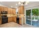 Bright kitchen with wood cabinets, granite countertops, and stainless steel appliances, offering style and functionality at 5612 S Jebel Way, Centennial, CO 80015