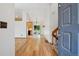 Bright living room showcasing wood floors, white walls, a staircase, and an open layout with access to the kitchen and backyard at 5612 S Jebel Way, Centennial, CO 80015