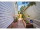 Side yard with a brick path and garden beds between two houses at 5612 S Jebel Way, Centennial, CO 80015