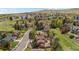 Scenic aerial view of neighborhood featuring manicured lawn, patio, mature trees and lush landscaping at 14533 W 3Rd Ave, Golden, CO 80401