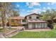 Charming backyard featuring a brick patio, sunroom and lawn with mature trees and lush landscaping at 14533 W 3Rd Ave, Golden, CO 80401