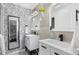 Stylish bathroom with dual vanities, modern fixtures, and patterned wallpaper at 14533 W 3Rd Ave, Golden, CO 80401