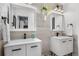 Bathroom with dual vanities, modern fixtures, and hanging plants at 14533 W 3Rd Ave, Golden, CO 80401