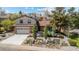 Charming home featuring a two-car garage, brick accents, and beautiful stone-planter landscaping at 14533 W 3Rd Ave, Golden, CO 80401