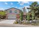 Charming home featuring a two-car garage, brick accents, and well-manicured landscaping at 14533 W 3Rd Ave, Golden, CO 80401