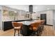 Modern kitchen with sleek countertops, an island with seating, and stainless steel appliances at 14533 W 3Rd Ave, Golden, CO 80401