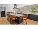 Modern kitchen with stainless steel hood, island with seating, and custom backsplash at 14533 W 3Rd Ave, Golden, CO 80401