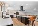 Open-concept kitchen featuring an island with cooktop, breakfast bar, and modern appliances at 14533 W 3Rd Ave, Golden, CO 80401