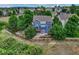 Expansive fenced backyard of this two-story home showing a large lawn and established trees for privacy at 4688 Cedar Glen Pl, Castle Rock, CO 80109