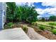 Landscaped backyard with a fire pit and brick pathway surrounded by established trees and a wooden fence at 4688 Cedar Glen Pl, Castle Rock, CO 80109