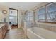 Bathroom with a walk-in glass shower, a separate soaking tub, and nice natural light at 4688 Cedar Glen Pl, Castle Rock, CO 80109