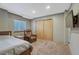 Bedroom featuring a comfortable recliner, carpeted floor, and mounted television at 4688 Cedar Glen Pl, Castle Rock, CO 80109