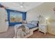 Well-lit bedroom with a modern ceiling fan, blue accent wall, and chair swing hanging near the window at 4688 Cedar Glen Pl, Castle Rock, CO 80109